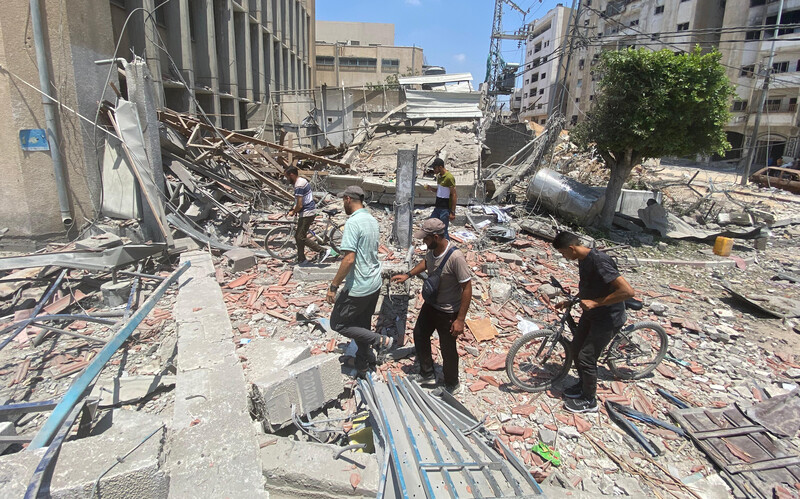 people look through rubble after an Israeli airstrike