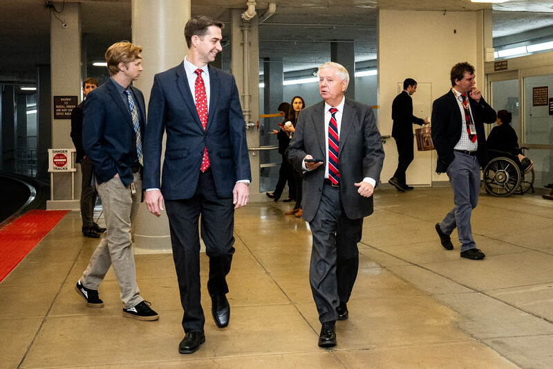 Senator Tom Cotton and Senator Lindsey Graham walk near the Senate Subway in the US Capitol Building