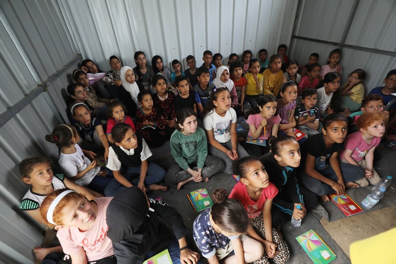 children crowded together during a lesson