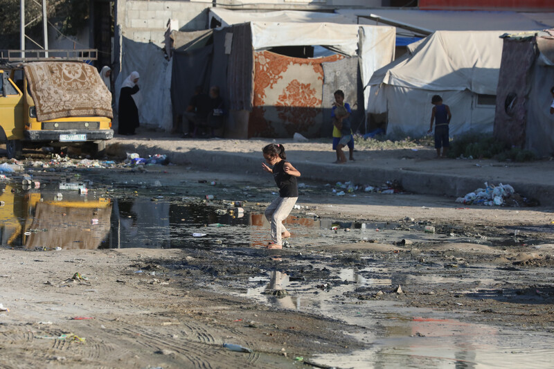 A girl walks through a puddle