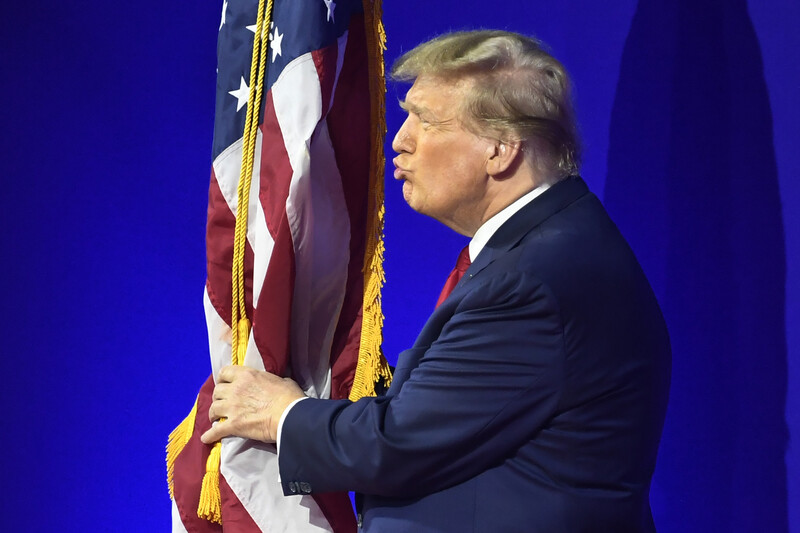 Donald Trump embraces and air kisses the American flag