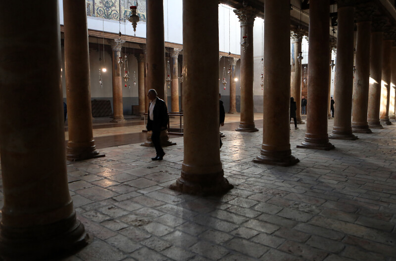 One person walks down the middle of an empty church