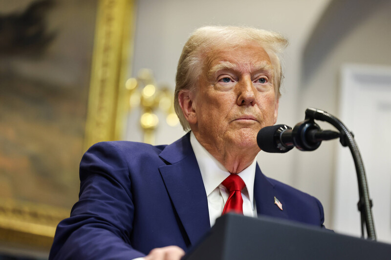 President Donald Trump behind a podium and microphone