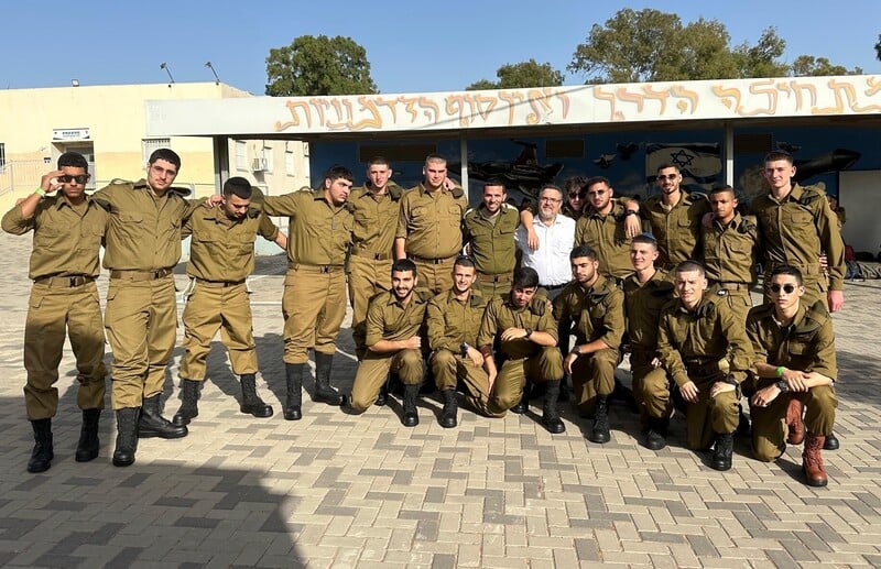 A group of soldiers outside a school