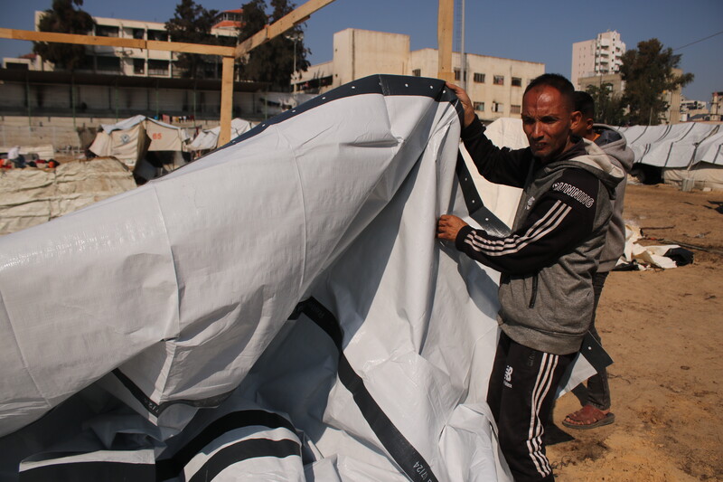 A man cconstructs a shelter