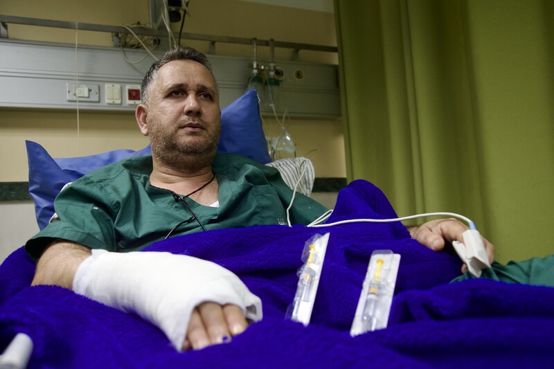 Dr. Abdullah Daher sits on a hospital bed at the public hospital in Jenin on 25 January. The doctor was treated at the facility for two gunshot wounds sustained in an Israeli sniper attack on the first day of the ongoing military assault.