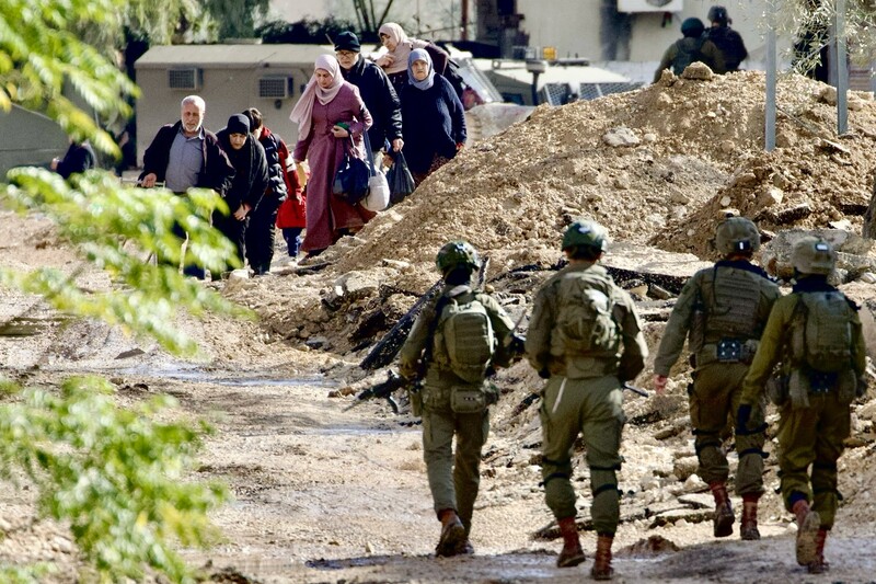  Israeli soldiers walk along a road as families evacuate their homes in Jenin on 23 January.