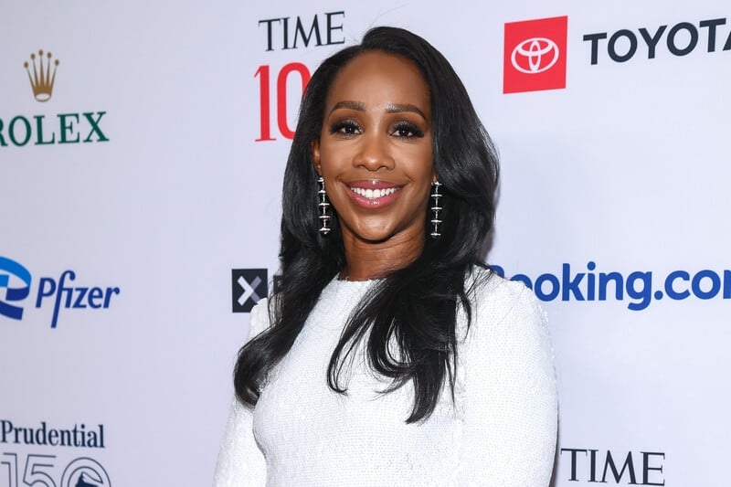 CNN anchor Abby Phillip at TIME 100 Gala with names of associated corporate partners behind her