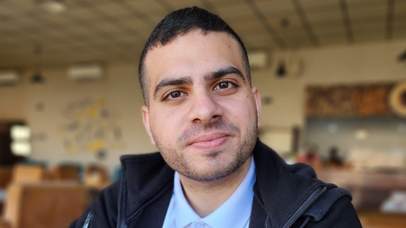A man smiles at the camera