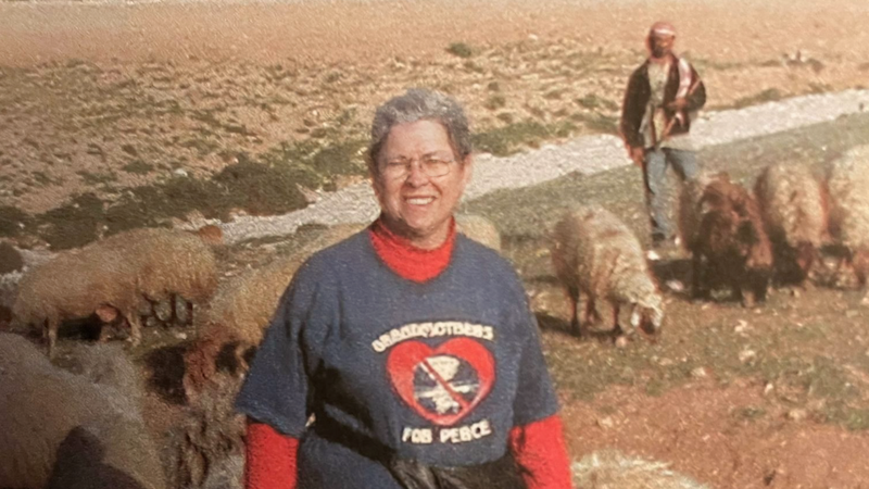 JoAnne Lingle in foreground and a man with sheep in background