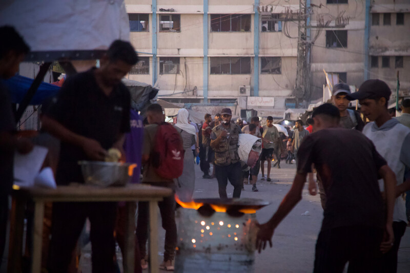 A street vendor prepares falafel at dusk
