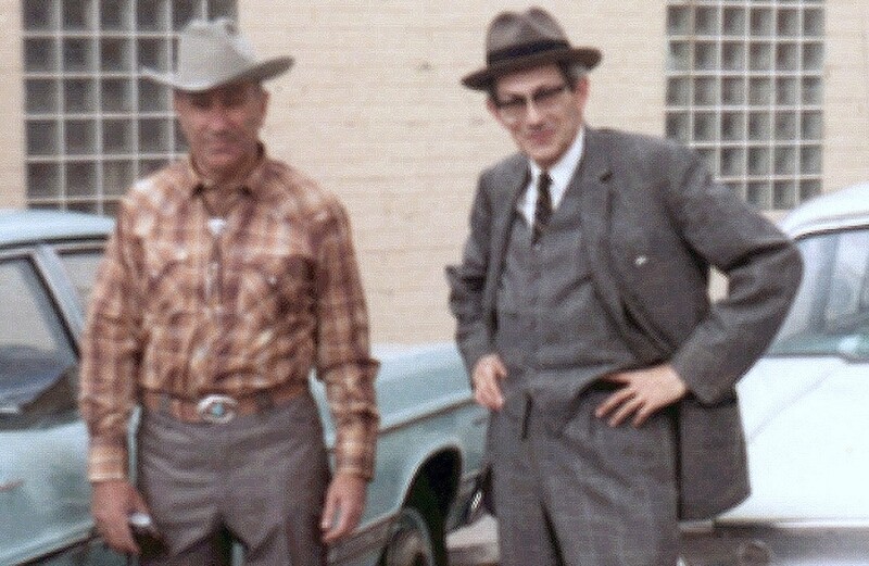 A man in a cowboy outfit and a man in a suit