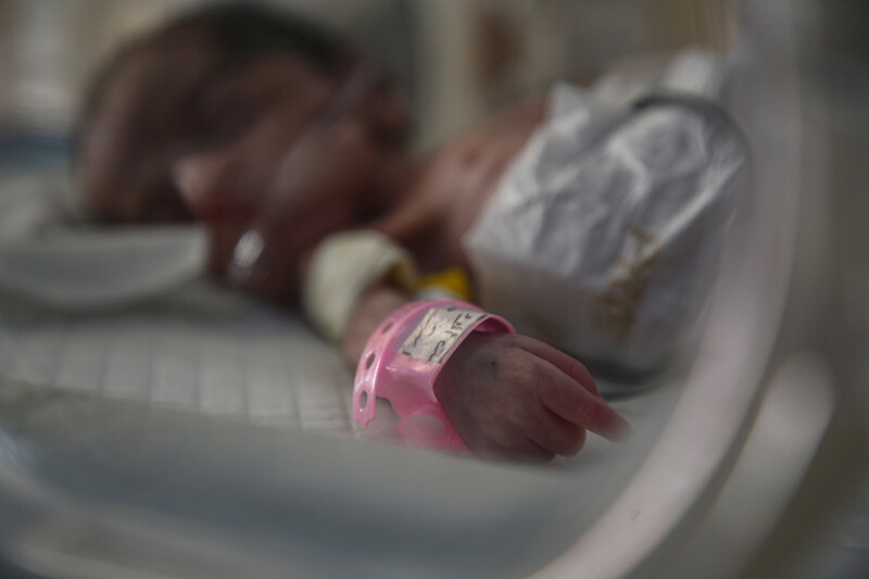 A premature infant in an incubator