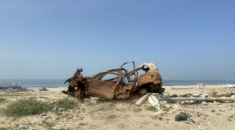 As the Israeli military shot at aid seekers, people hid behind whatever they could find nearby, including cars such as this one near the al-Nabulsi roundabout, Gaza City, February 2026.