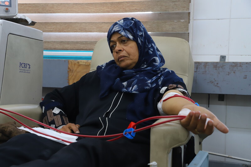 A woman receives dialysis