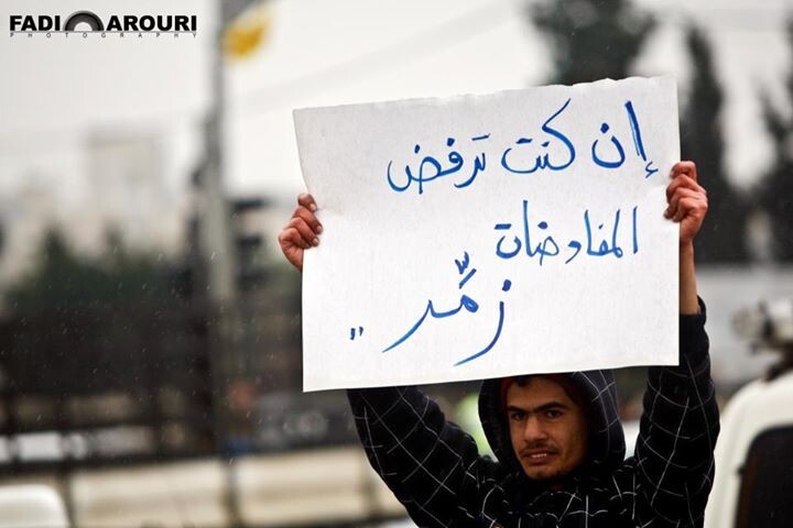 A Palestinian Holds a banner Against Palestinian