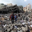 Two boys standing in the middle of rubble