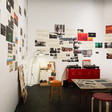 Brightly-lit room with collage of photographs on walls