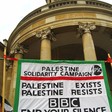 Banner reads: Palestine exists, Palestine resists, BBC end your silence
