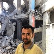 Raed Issa standing beside the apartment block that was previously his home, and that of eight other households