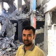 Raed Issa standing beside the apartment block that was previously his home, and that of eight other households