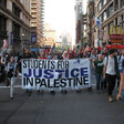 Protesters hold a banner.