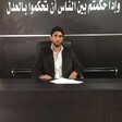 Young man wearing blazer sits at law college desk