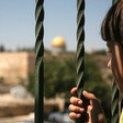 A Palestinian boy looks at the Dome of the Rock mosque as Israeli police blocks the access to al-Aqsa Mosque, outside the Old City walls in East Jerusalem. 