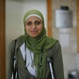Dareen Tatour stands in court on crutches.