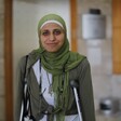 Dareen Tatour stands in court on crutches. 