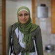 Dareen Tatour stands in court on crutches. 