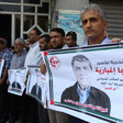 Palestinians hold pictures of Raja Eghbaria