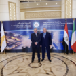 Israeli energy minister Yuval Steinitz and Israel’s ambassador to Egypt David Govrin stand in front of a backdrop to the First Ministerial Meeting of the Eastern Mediterranean Gas Forum. 