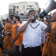 A man speaks into a megaphone