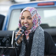 Representative Ilhan Omar speaks into a microphone. 