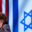 A woman at a podium in front of American and Israeli flags