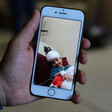 A picture on a mobile phone shows a bandaged girl smiling