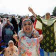 Close-up of a woman gesticulating with other women behind her