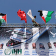 Large banner with flags, photos and names of victims