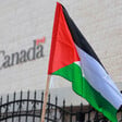 Palestinian flag flies in front of building marked Canada