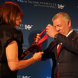 Woman gives man medal 