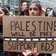 A woman holds a sign at a protest