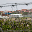 Landscape view of settlement homes with barbed wire in foreground