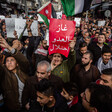 Hundreds of protesters hold banners, flags 