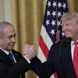 Two men clasp hands