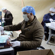 People wearing hair nets and masks at work