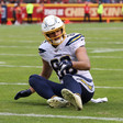 American football player sits on ground