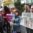 People standing, holding signs