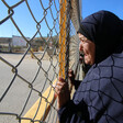 Woman holds barbed wire