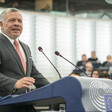 Man in suit standing before podium